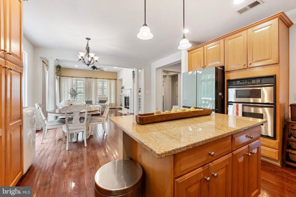 Chandelier, Dining room, Fireplace, Interior, Kitchen, Pendant Lights, Recessed Lighting, Stainless Steel Appliances, Wood Texture Flooring