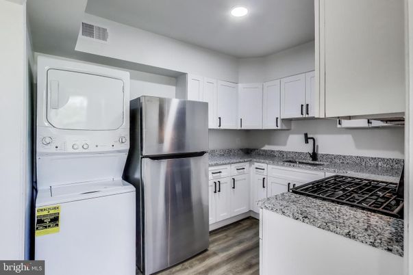 Interior, Kitchen, Recessed Lighting, Washer, Wood Texture Flooring