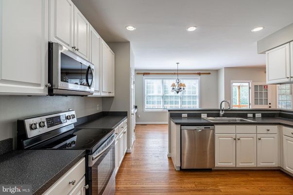 Chandelier, Interior, Kitchen, Pendant Lights, Recessed Lighting, Stainless Steel Appliances, Wood Texture Flooring