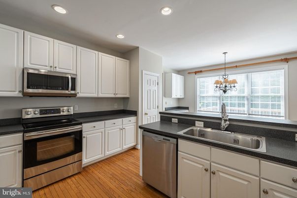 Chandelier, Interior, Kitchen, Pendant Lights, Recessed Lighting, Stainless Steel Appliances, Wood Texture Flooring