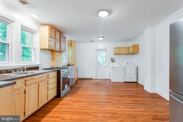Interior, Kitchen, Recessed Lighting, Washer, Wood Texture Flooring