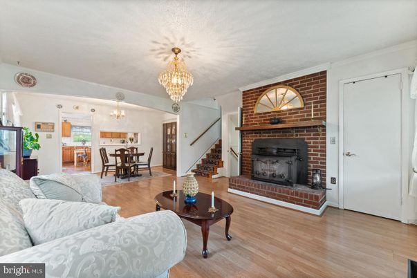 Chandelier, Dining room, Fireplace, Interior, Living room, Stone Walls, Wood Texture Flooring