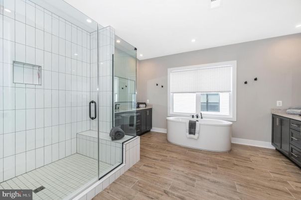 Bathroom, Free Standing Baths, Glass Shower, Interior, Recessed Lighting, Wood Texture Flooring