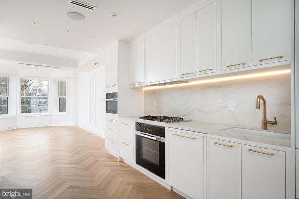 Interior, Kitchen, Marble Walls, Pendant Lights, Recessed Lighting, Stainless Steel Appliances, Wood Texture Flooring
