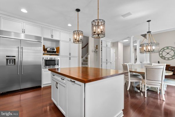 Chandelier, Dining room, Interior, Kitchen, Pendant Lights, Recessed Lighting, Stainless Steel Appliances, Wood Texture Flooring
