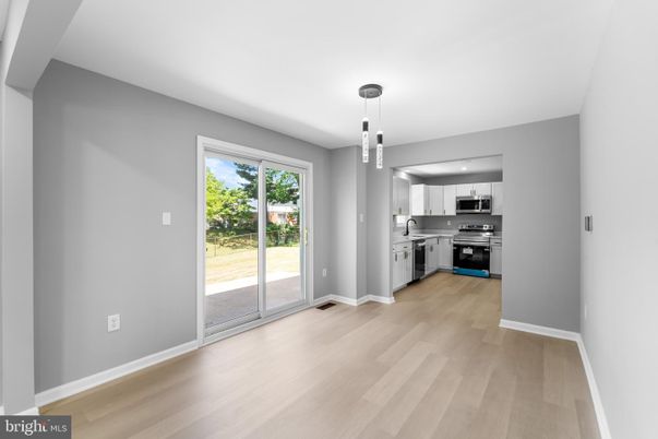 Empty room, Interior, Kitchen, Pendant Lights, Stainless Steel Appliances, Wood Texture Flooring