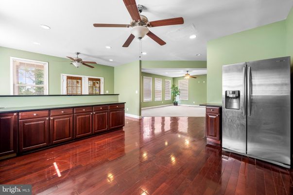 Empty room, Interior, Kitchen, Recessed Lighting, Stainless Steel Appliances, Wood Texture Flooring