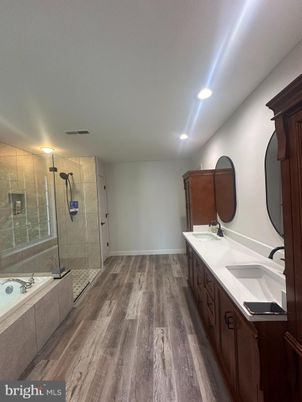 Bathroom, Dual Sink Vanities, Glass Shower, Interior, Recessed Lighting, Wood Texture Flooring
