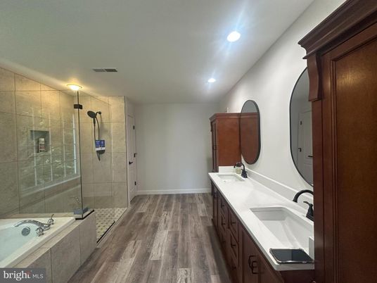 Bathroom, Dual Sink Vanities, Glass Shower, Interior, Recessed Lighting, Wood Texture Flooring