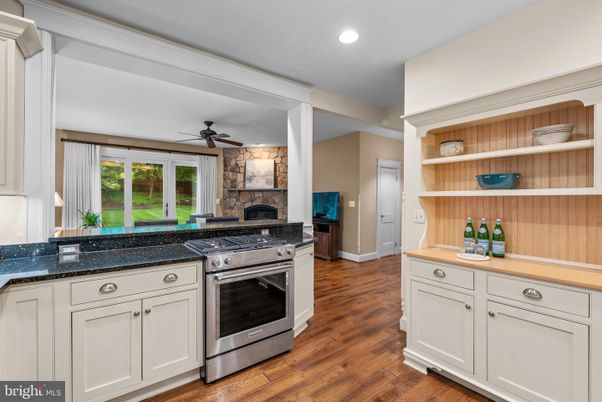 Fireplace, Interior, Kitchen, Recessed Lighting, Stainless Steel Appliances, Wood Texture Flooring