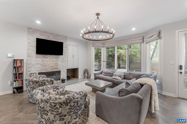 Chandelier, Fireplace, Interior, Living room, Recessed Lighting, Stone Walls, Wood Texture Flooring