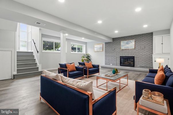 Fireplace, Interior, Living room, Recessed Lighting, Stone Walls, Wood Texture Flooring