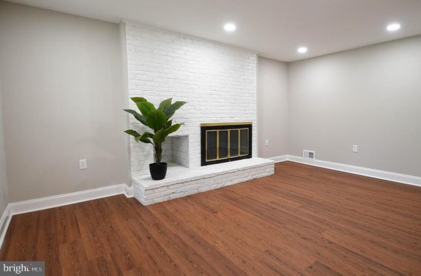 Empty room, Fireplace, Interior, Recessed Lighting, Stone Walls, Wood Texture Flooring