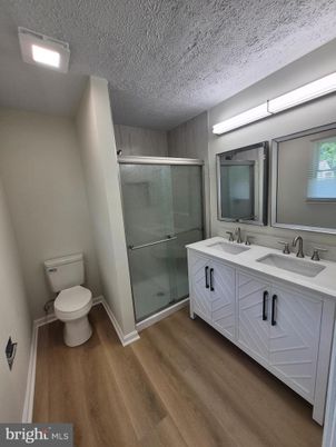 Bathroom, Dual Sink Vanities, Glass Shower, Interior, Wood Texture Flooring