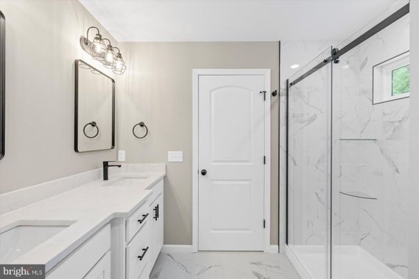 Bathroom, Dual Sink Vanities, Glass Shower, Interior, Marble, Marble Walls, Recessed Lighting