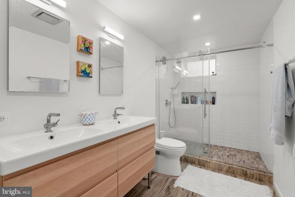 Bathroom, Dual Sink Vanities, Glass Shower, Interior, Recessed Lighting, Wood Texture Flooring