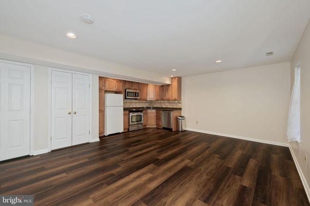 Empty room, Interior, Kitchen, Recessed Lighting, Stainless Steel Appliances, Wood Texture Flooring