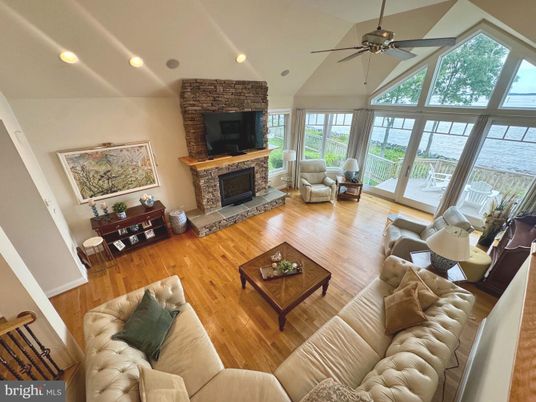 Fireplace, Interior, Living room, Recessed Lighting, Stone Walls, Water, Wood Texture Flooring