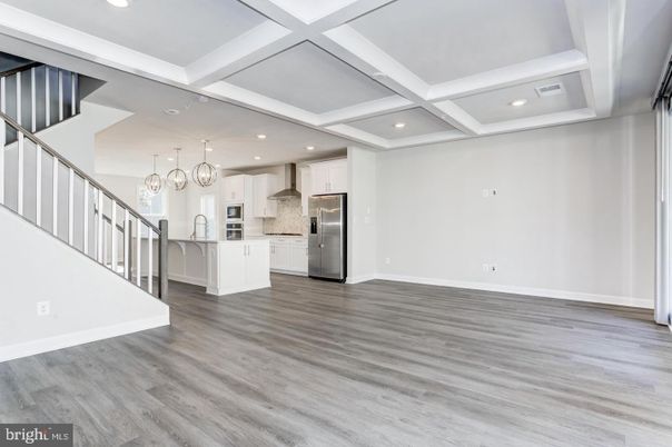 Empty room, Interior, Kitchen, Pendant Lights, Recessed Lighting, Stainless Steel Appliances, Wood Texture Flooring