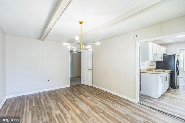 Empty room, Interior, Kitchen, Pendant Lights, Recessed Lighting, Washer, Wood Texture Flooring