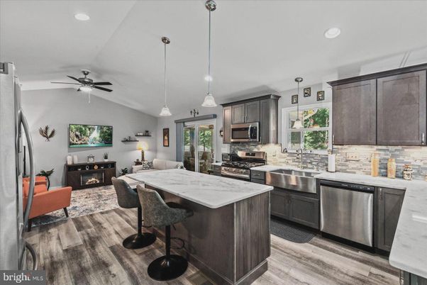 Fireplace, Interior, Kitchen, Living room, Pendant Lights, Recessed Lighting, Stainless Steel Appliances, Wood Texture Flooring