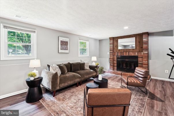 Fireplace, Interior, Living room, Recessed Lighting, Stone Walls, Wood Texture Flooring