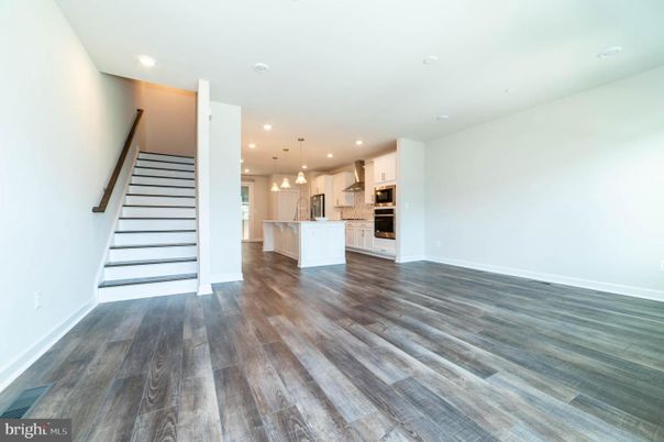 Empty room, Interior, Kitchen, Pendant Lights, Recessed Lighting, Stainless Steel Appliances, Wood Texture Flooring