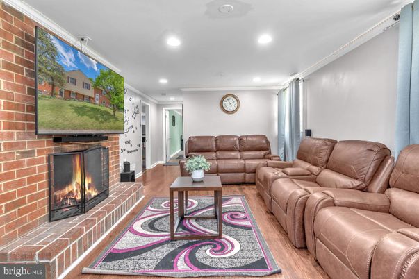 Fireplace, Interior, Living room, Recessed Lighting, Stone Walls, Wood Texture Flooring