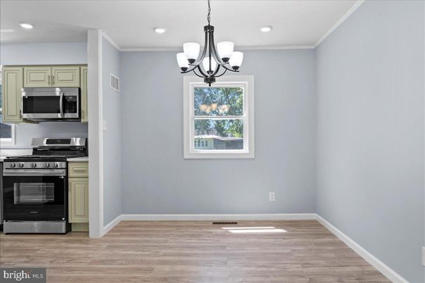 Chandelier, Empty room, Interior, Kitchen, Recessed Lighting, Stainless Steel Appliances, Wood Texture Flooring