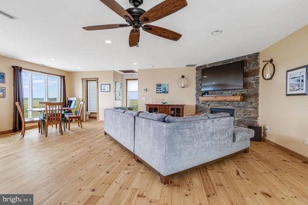 Dining room, Fireplace, Interior, Living room, Recessed Lighting, Stone Walls, Wood Texture Flooring