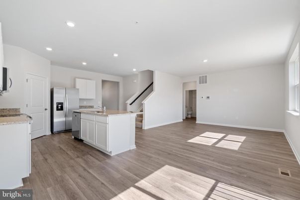 Empty room, Interior, Kitchen, Recessed Lighting, Stainless Steel Appliances, Wood Texture Flooring
