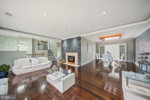 Dining room, Fireplace, Interior, Living room, Recessed Lighting, Stone Walls, Wood Texture Flooring