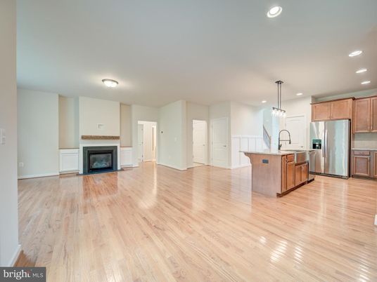 Empty room, Fireplace, Interior, Kitchen, Pendant Lights, Recessed Lighting, Stainless Steel Appliances, Wood Texture Flooring