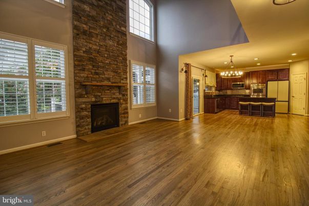 Chandelier, Empty room, Fireplace, Interior, Kitchen, Pendant Lights, Recessed Lighting, Stone Walls, Wood Texture Flooring