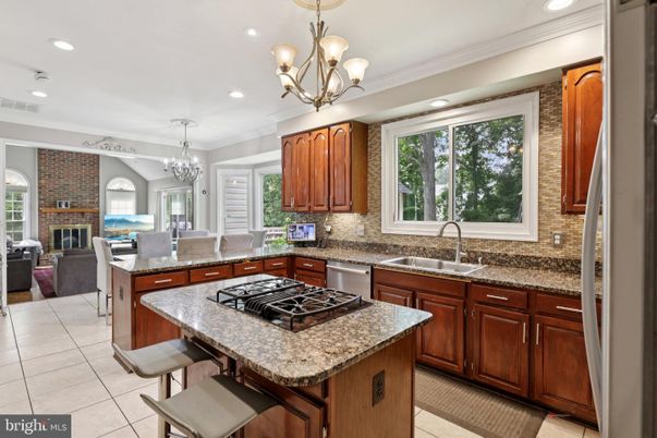 Chandelier, Dining room, Fireplace, Interior, Kitchen, Living room, Recessed Lighting, Stainless Steel Appliances, Stone Walls