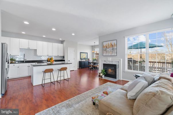 Fireplace, Interior, Kitchen, Living room, Pendant Lights, Recessed Lighting, Stainless Steel Appliances, Wood Texture Flooring