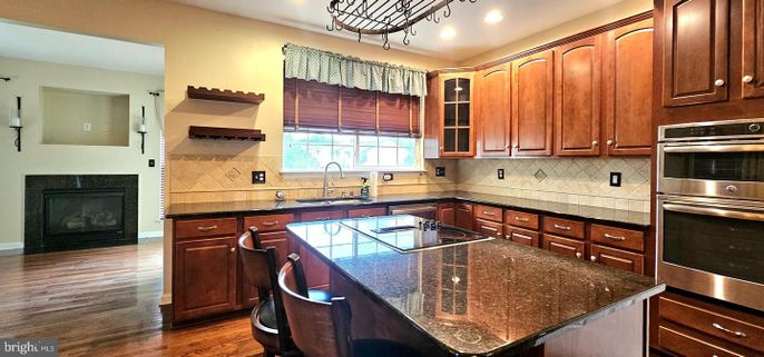 Fireplace, Interior, Kitchen, Recessed Lighting, Stainless Steel Appliances, Wood Texture Flooring