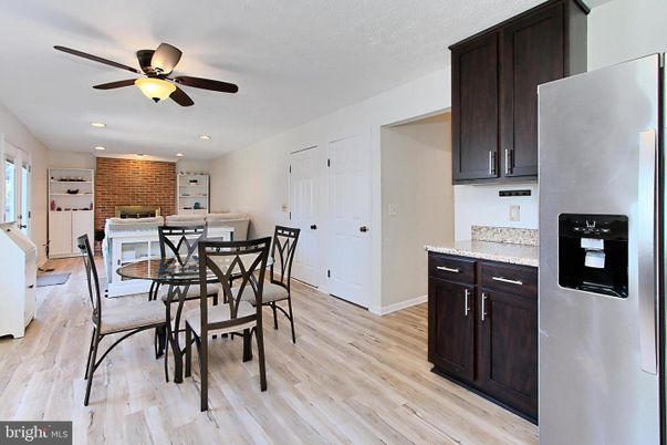 Dining room, Fireplace, Interior, Kitchen, Recessed Lighting, Stone Walls, Wood Texture Flooring