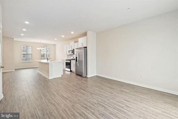 Chandelier, Empty room, Interior, Kitchen, Recessed Lighting, Stainless Steel Appliances, Wood Texture Flooring