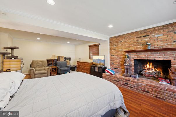 Bedroom, Fireplace, Interior, Recessed Lighting, Stone Walls, Wood Texture Flooring