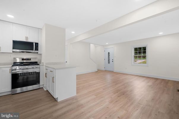 Empty room, Interior, Kitchen, Recessed Lighting, Stainless Steel Appliances, Wood Texture Flooring