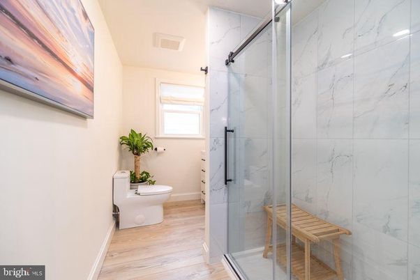Bathroom, Glass Shower, Interior, Marble Walls, Wood Texture Flooring