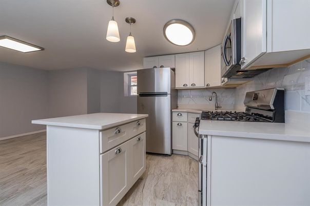 Interior, Kitchen, Marble, Marble Walls, Pendant Lights, Stainless Steel Appliances, Wood Texture Flooring