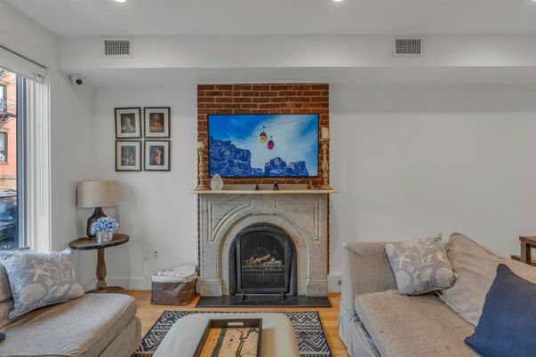 Fireplace, Interior, Living room, Recessed Lighting, Stone Walls, Wood Texture Flooring
