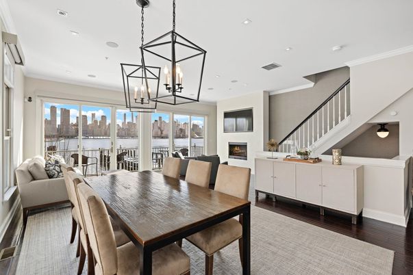 Dining room, Fireplace, Interior, Living room, Pendant Lights, Recessed Lighting, Water, Wood Texture Flooring