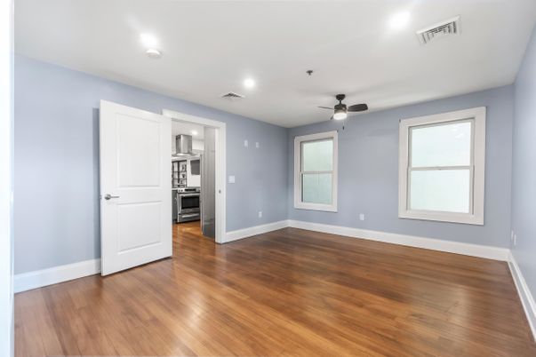 Empty room, Interior, Kitchen, Recessed Lighting, Stainless Steel Appliances, Wood Texture Flooring
