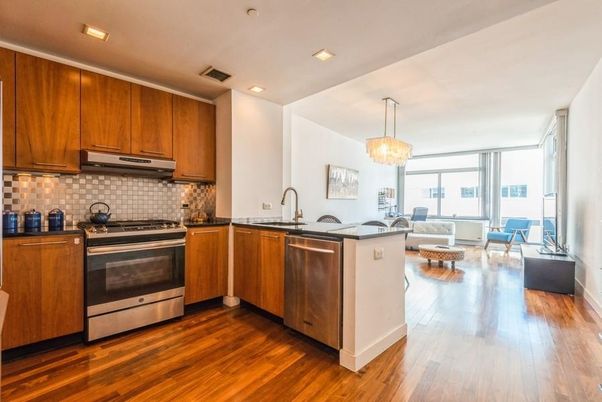 Chandelier, Dining room, Interior, Kitchen, Living room, Pendant Lights, Recessed Lighting, Stainless Steel Appliances, Wood Texture Flooring