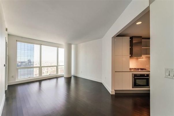 Empty room, Interior, Kitchen, Recessed Lighting, Stainless Steel Appliances, Wood Texture Flooring