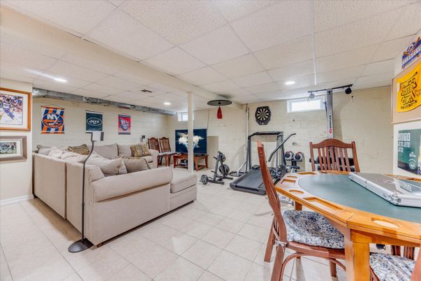 Fitness Equipment, Game Room, Interior, Living room, Recessed Lighting, Stone Walls