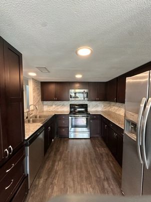 Interior, Kitchen, Marble Walls, Recessed Lighting, Stainless Steel Appliances, Wood Texture Flooring